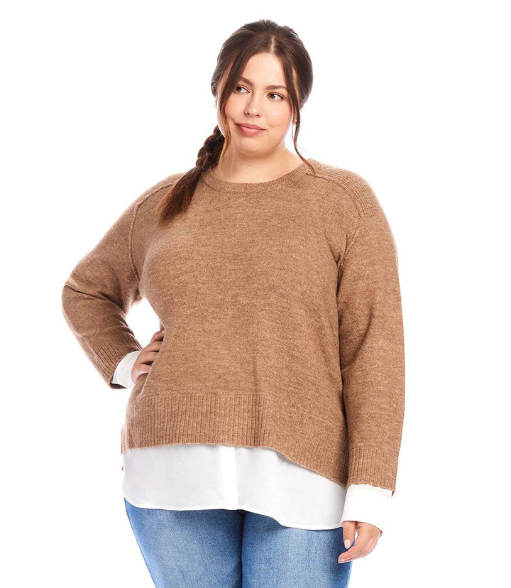 Plus size layered crewneck sweater in brown with contrast shirttail hem and raglan sleeves worn by a woman