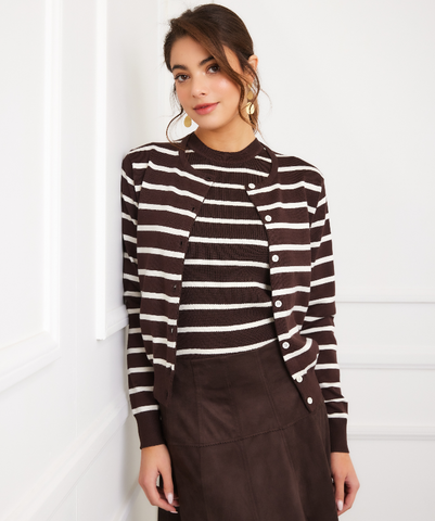 Woman wearing a brown and white striped sweater against a white background