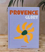 Provence Glory hardcover coffee table book with blue cover and orange floral design about South of France culture and landscapes