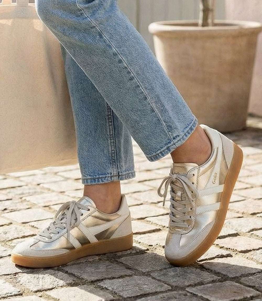Gola Viper Metallic Sneakers in gold with white stripes, leather and suede, lace-up design, cushioned sole, and gum rubber outsole