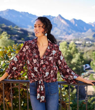 Blouson sleeve tie-front top in wine floral crepe with notched collar and gathered cuffs
