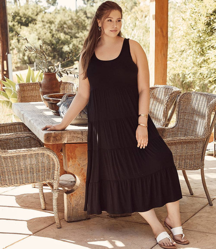 Plus size tiered midi dress in black sleeveless jersey with scoop neckline and flouncy hem