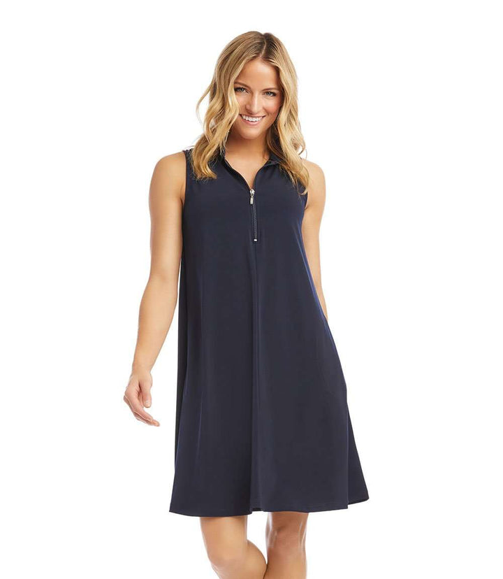 Woman wearing sleeveless zip-up navy travel dress with side pockets and relaxed fit