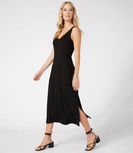 Woman wearing black Brigitte Midi Dress with double V-neck and side slit