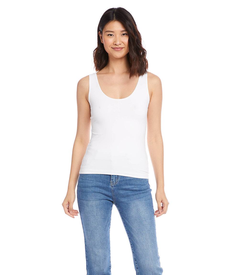 Petite size scoop tank with fitted sleeveless design in white worn with blue jeans