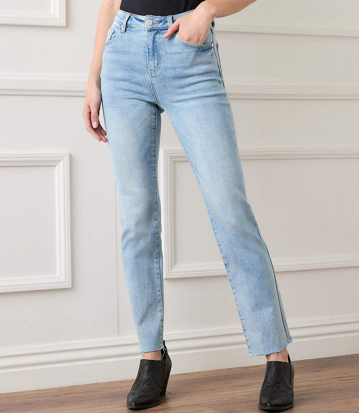 Light blue faded raw hem straight jeans with ankle length and five-pocket design worn with black shoes